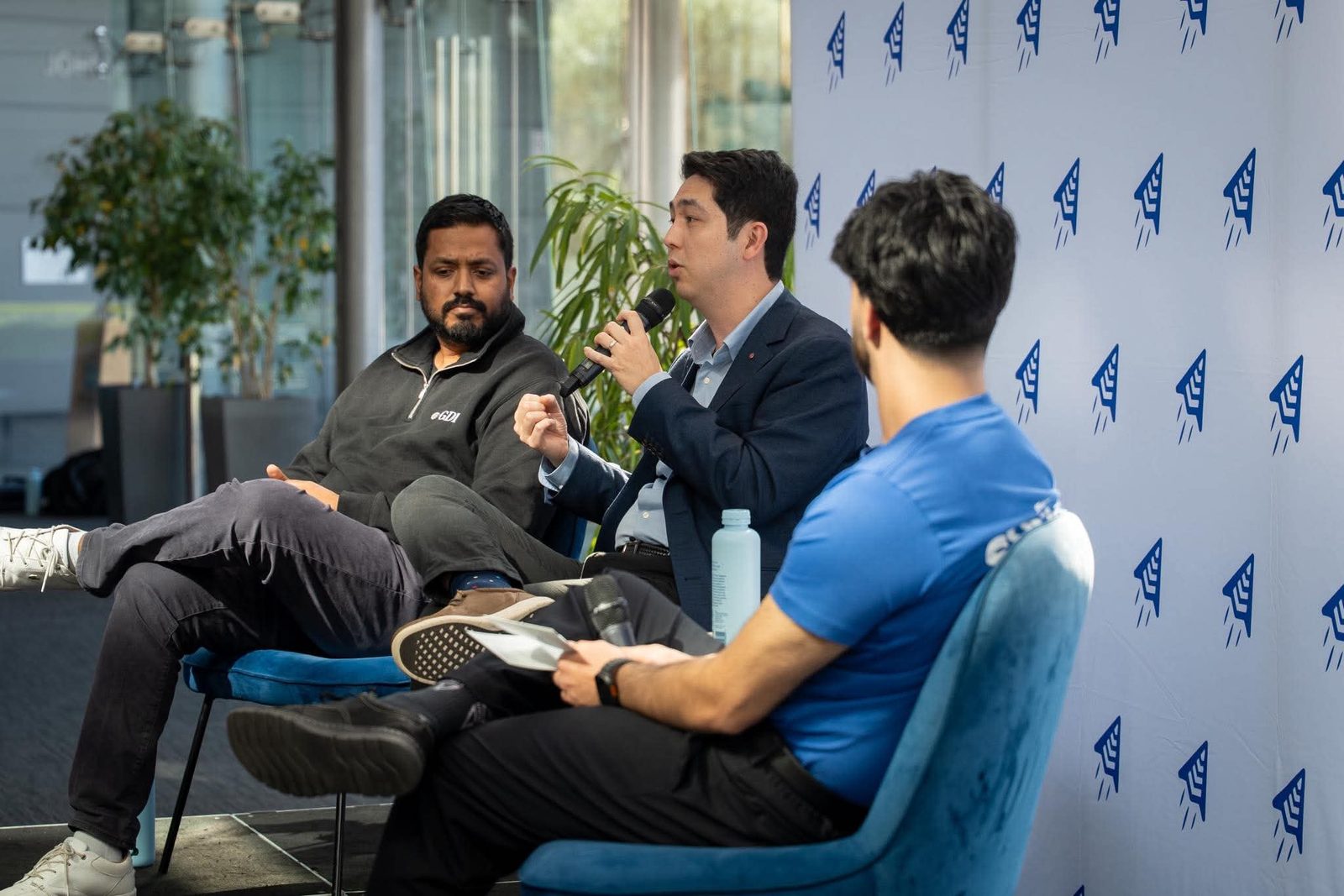 Panel discussion in front of the Summit backdrop